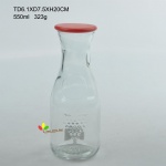 Glass juice bottle with lid embossed design